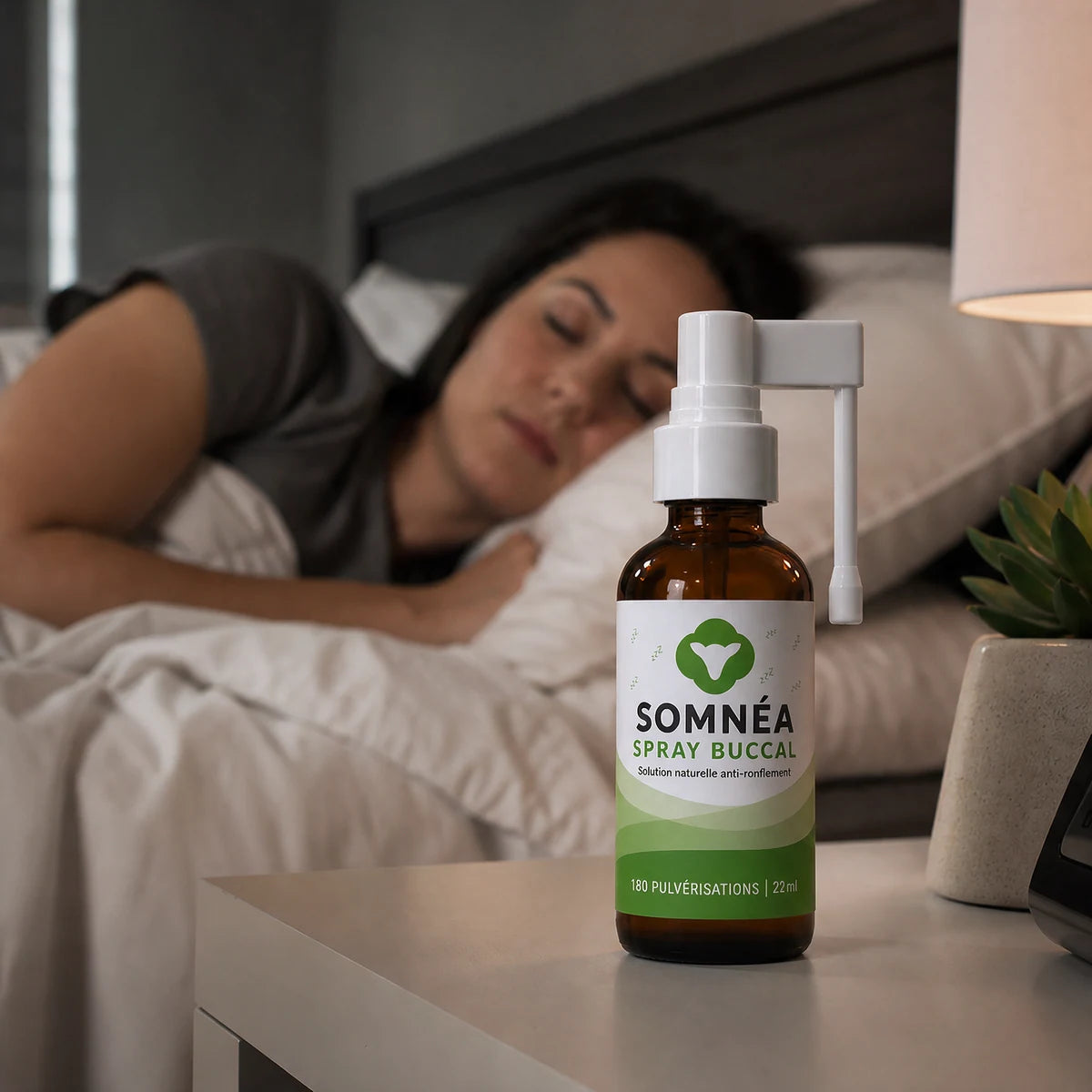 Une femme dort profondément, le flacon SOMNÉA à côté du lit